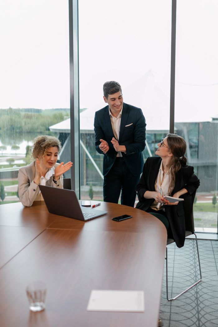 Team of professionals collaborating in an office setting, showcasing a successful meeting.